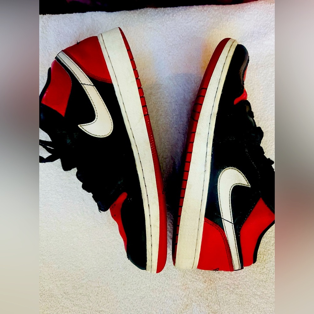 Nike Air Jordan 1 Low in the Gym Red/White/Black colorway.